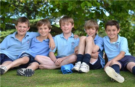 5 young boys with arms around each others shoulders